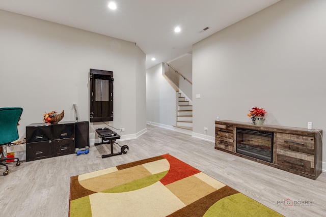 interior space featuring recessed lighting, wood finished floors, stairs, baseboards, and visible vents