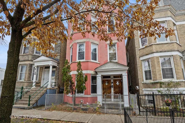 2534 S Christiana Ave, Chicago, IL 60623 - view of front of house featuring a gate, brick siding, and a fenced front yard