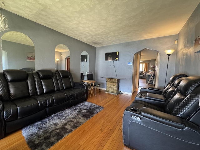 10434 S Green St, Chicago, IL 60643 - living room with arched walkways, baseboards, hardwood / wood-style flooring, and a textured ceiling