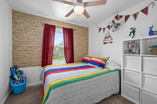 carpeted bedroom featuring baseboards, wood walls, and ceiling fan