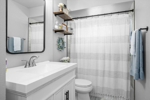 bathroom featuring vanity, toilet, and a shower with curtain