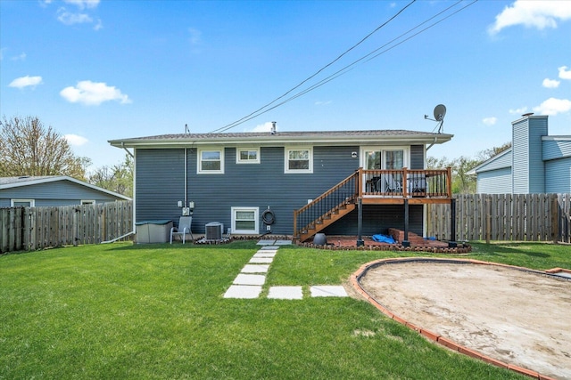 back of property with stairs, a deck, a fenced backyard, cooling unit, and a yard