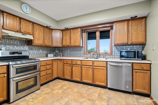 911 E Main St, Plano, IL 60545 - kitchen featuring stainless steel appliances, under cabinet range hood, a sink, and light countertops