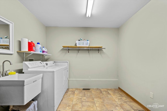 911 E Main St, Plano, IL 60545 - laundry room with washing machine and clothes dryer, stone finish flooring, and baseboards