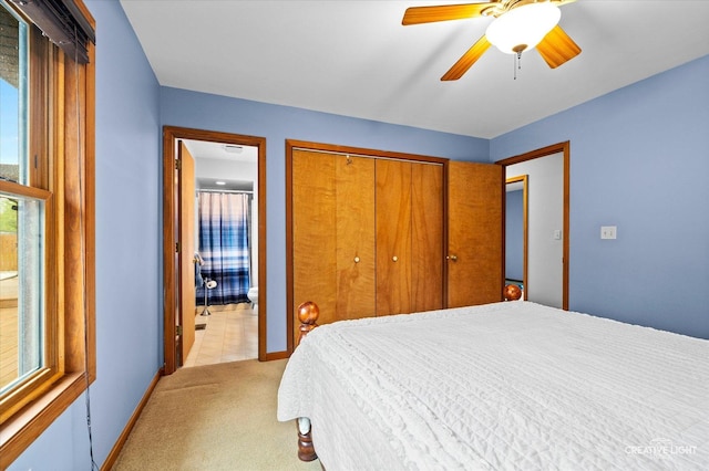 911 E Main St, Plano, IL 60545 - bedroom with light carpet, a closet, ensuite bathroom, baseboards, and ceiling fan