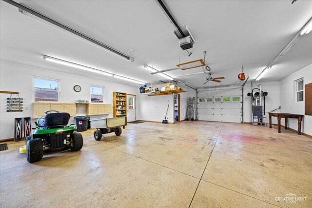 911 E Main St, Plano, IL 60545 - garage featuring a garage door opener and baseboards