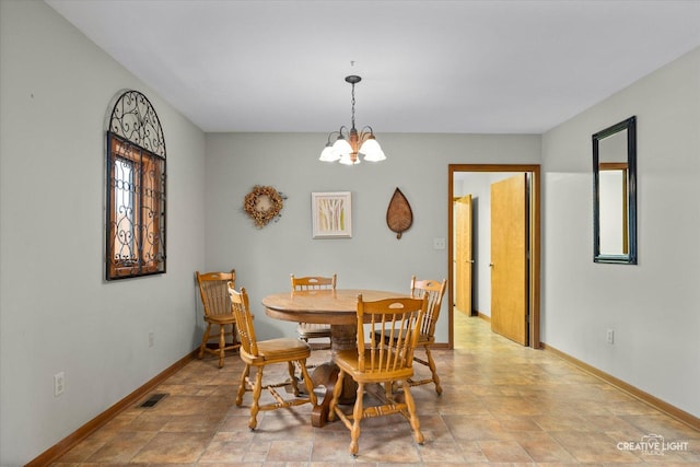 911 E Main St, Plano, IL 60545 - dining area with baseboards, a chandelier, and stone finish floors