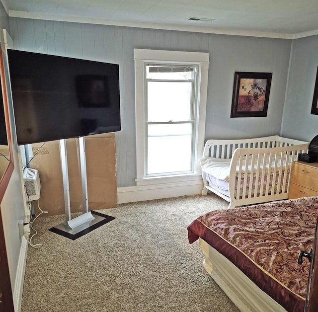 carpeted bedroom featuring ornamental molding and visible vents