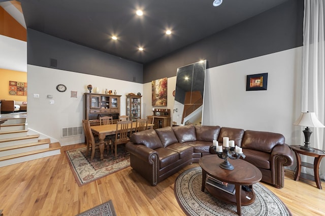 535 N Wood St, Chicago, IL 60622 - living room with a high ceiling, stairs, visible vents, and light wood-style floors