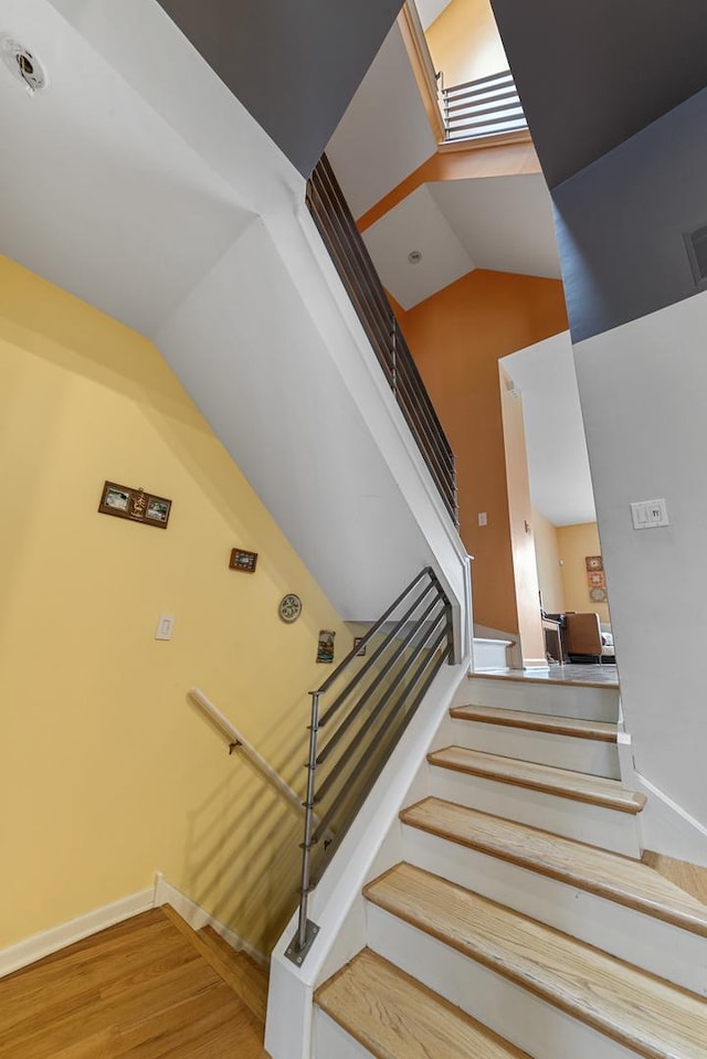 535 N Wood St, Chicago, IL 60622 - stairway featuring wood finished floors, high vaulted ceiling, visible vents, and baseboards