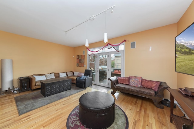 535 N Wood St, Chicago, IL 60622 - living area with track lighting, wood finished floors, and visible vents
