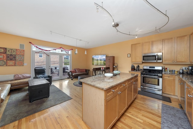 535 N Wood St, Chicago, IL 60622 - kitchen featuring track lighting, open floor plan, stainless steel appliances, and light wood-style flooring