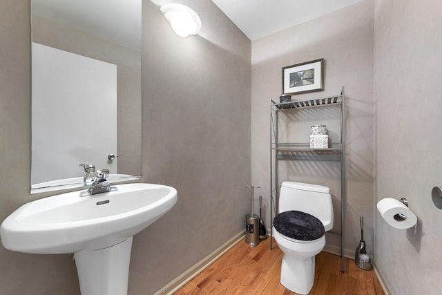 535 N Wood St, Chicago, IL 60622 - half bathroom featuring toilet, wood finished floors, and baseboards