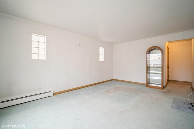 spare room with carpet, baseboards, ornamental molding, and a baseboard radiator