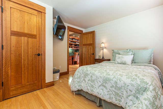 bedroom with baseboards and light wood-type flooring