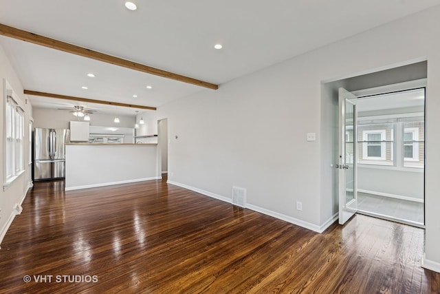 unfurnished living room with visible vents, dark wood-style flooring, ceiling fan, and beam ceiling