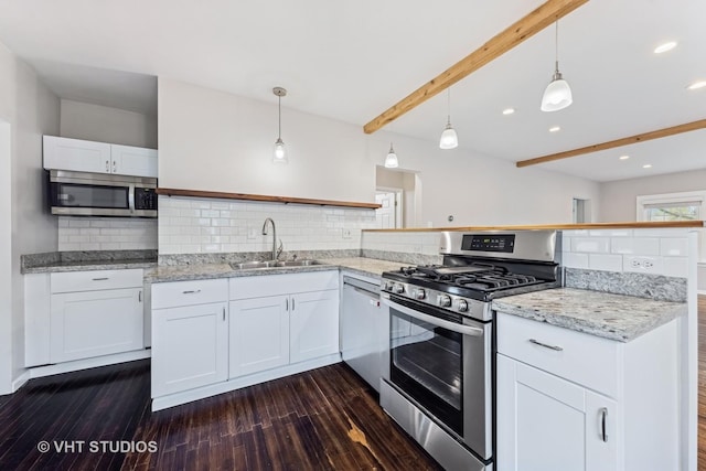kitchen featuring beam ceiling, appliances with stainless steel finishes, dark wood-style floors, and a sink