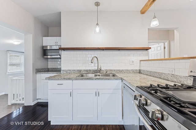 kitchen with backsplash, open shelves, a sink, white cabinets, and stainless steel appliances