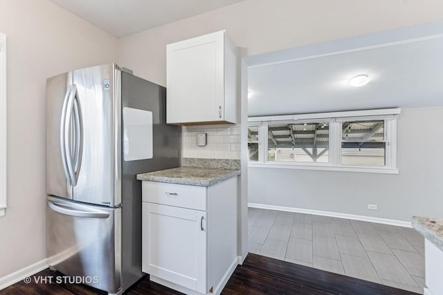 kitchen featuring freestanding refrigerator, white cabinetry, baseboards, and dark wood-style flooring