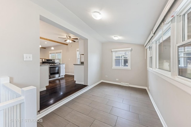 spare room with visible vents, a ceiling fan, plenty of natural light, and lofted ceiling