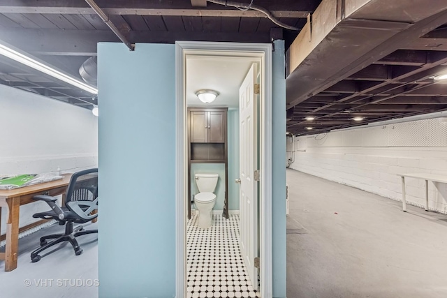 interior space with concrete block wall and concrete floors