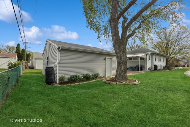 rear view of house featuring a lawn, central AC, and fence