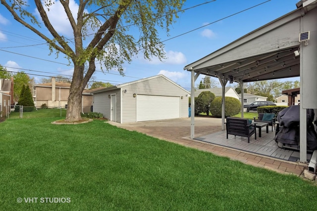 view of yard with fence, an outbuilding, and a garage