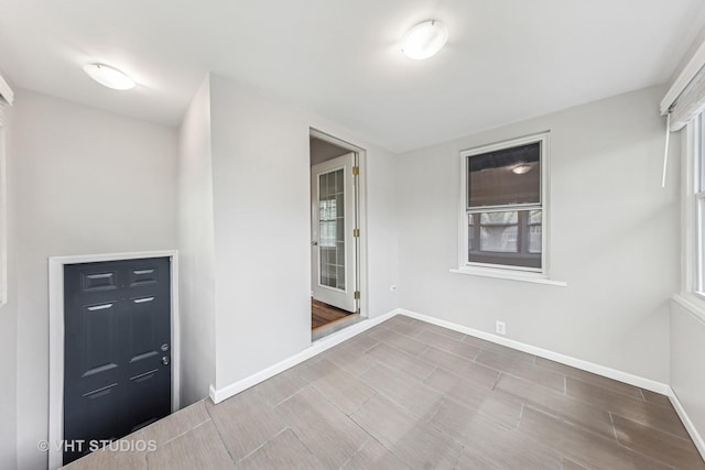 spare room featuring baseboards