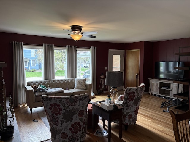 living area featuring wood finished floors and ceiling fan