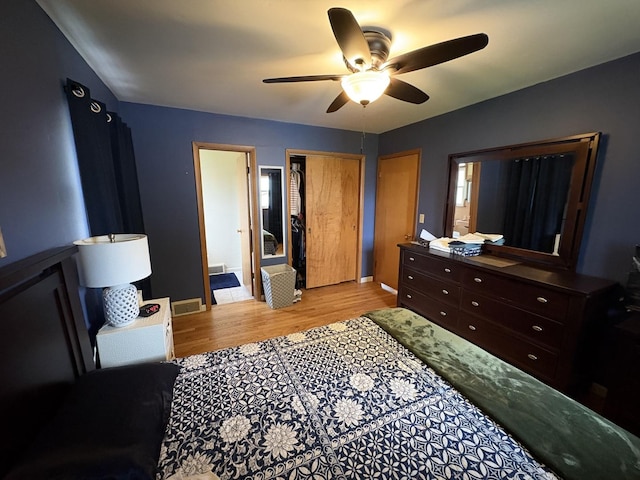 bedroom with visible vents, light wood-type flooring, and a ceiling fan