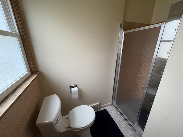 bathroom with tile patterned floors, visible vents, a shower stall, and toilet