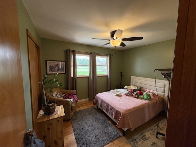 bedroom featuring wood finished floors and a ceiling fan