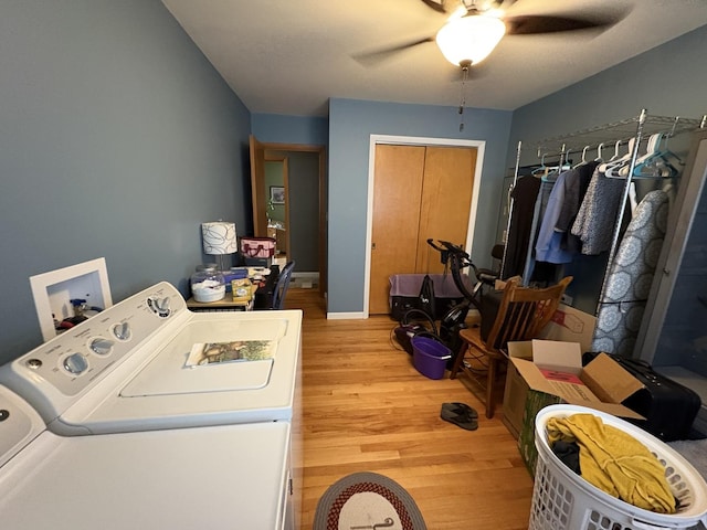 laundry room featuring light wood finished floors, washing machine and clothes dryer, laundry area, a ceiling fan, and baseboards
