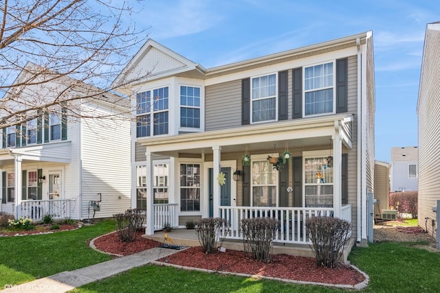 traditional-style home with a porch and a front yard