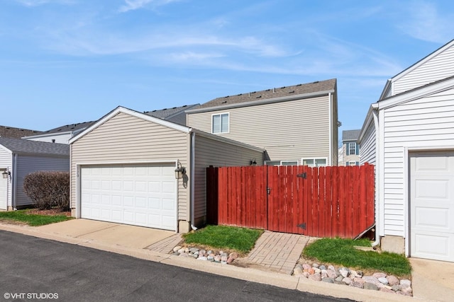 exterior space with an outdoor structure, a garage, and fence