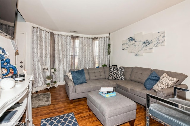 living area featuring wood finished floors and visible vents