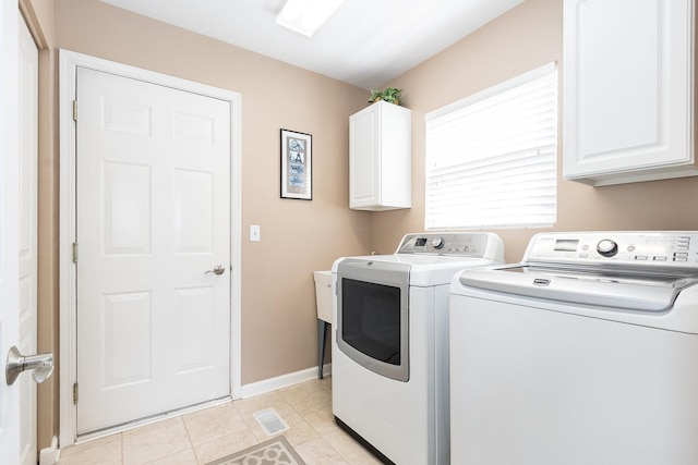 laundry area with washer and dryer, cabinet space, baseboards, light tile patterned floors, and visible vents