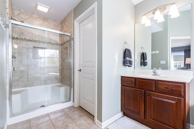 full bath featuring vanity, tile patterned floors, and a shower stall