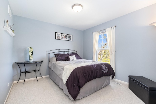 bedroom with visible vents, carpet, and baseboards