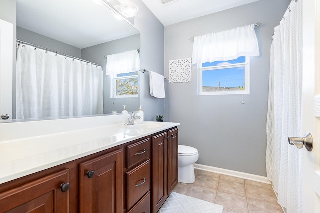 full bathroom with vanity, baseboards, tile patterned flooring, and toilet