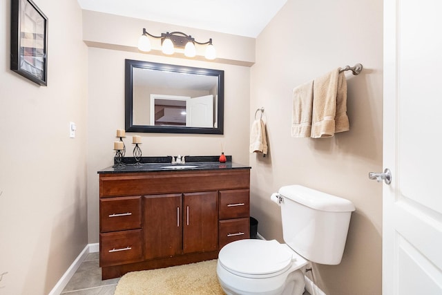 bathroom with baseboards, toilet, and vanity
