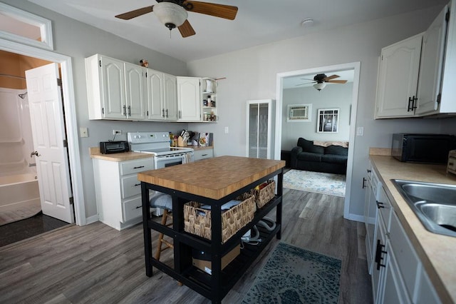 kitchen with black microwave, white electric range oven, a ceiling fan, and dark wood-type flooring