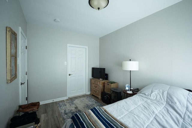 bedroom with wood finished floors and baseboards