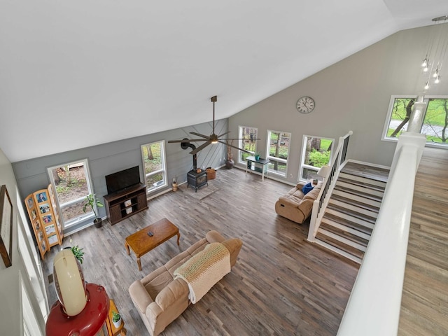 living room featuring a ceiling fan, high vaulted ceiling, stairs, and wood finished floors