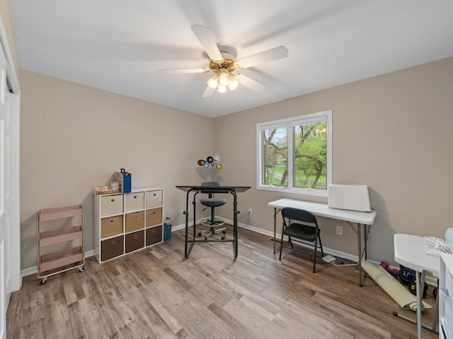 office area featuring wood finished floors, ceiling fan, and baseboards