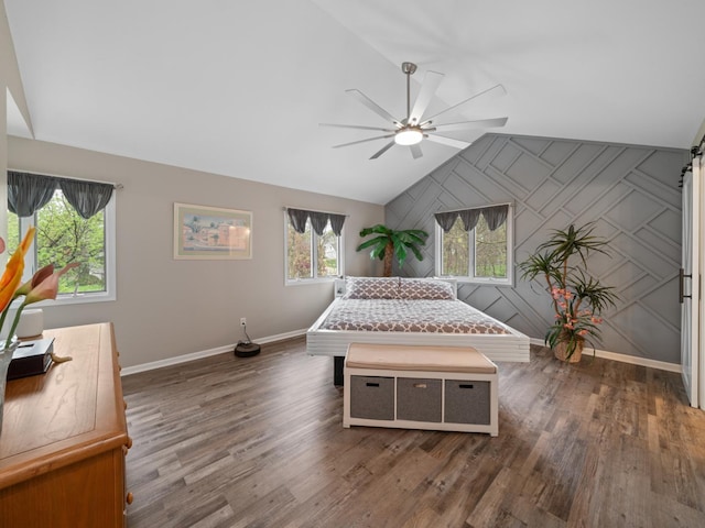 bedroom featuring ceiling fan, vaulted ceiling, wood finished floors, and baseboards
