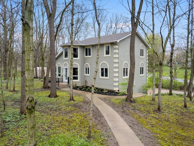 colonial house featuring stucco siding