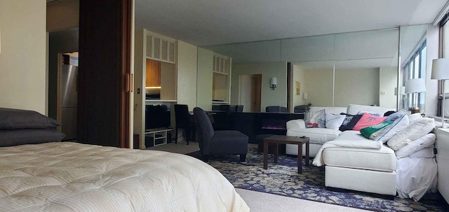 bedroom with freestanding refrigerator