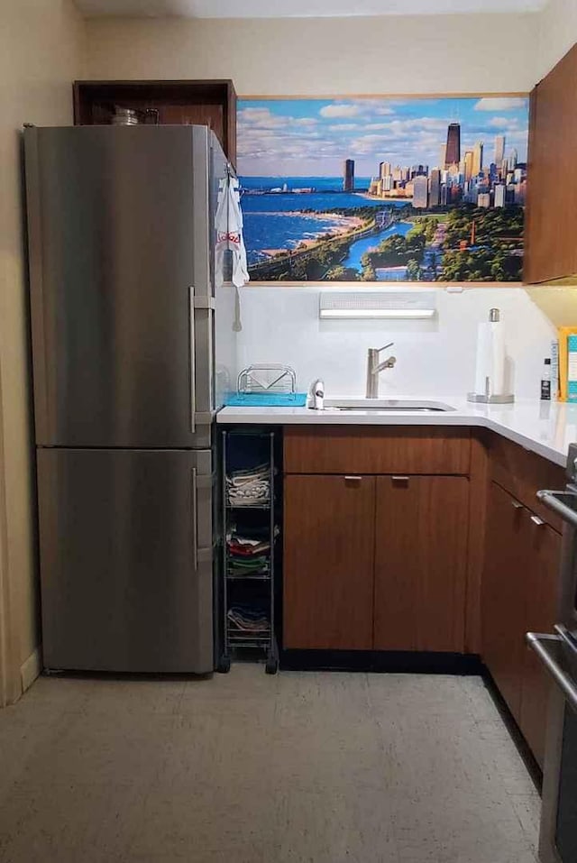 bar with freestanding refrigerator, a sink, and a water view