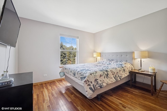 bedroom featuring wood-type flooring and baseboards
